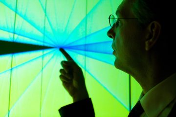 A professor introduces Tufts' new Center for Scientific Visualization to visitors. The VisWall, as users call it, is located at the School of Engineering in Anderson Hall, and features a high-resolution rear-projection display that increases the amount of visible detail in an image.